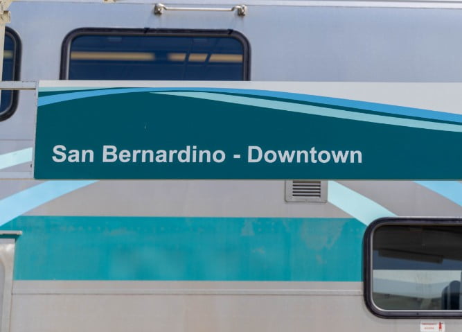 Banner reading 'San Bernardino - Downtown' in front of a train
